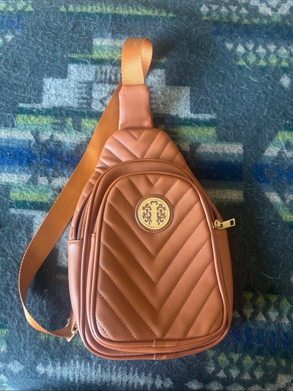 Brown Quilted Sling Bag with Gold Emblem